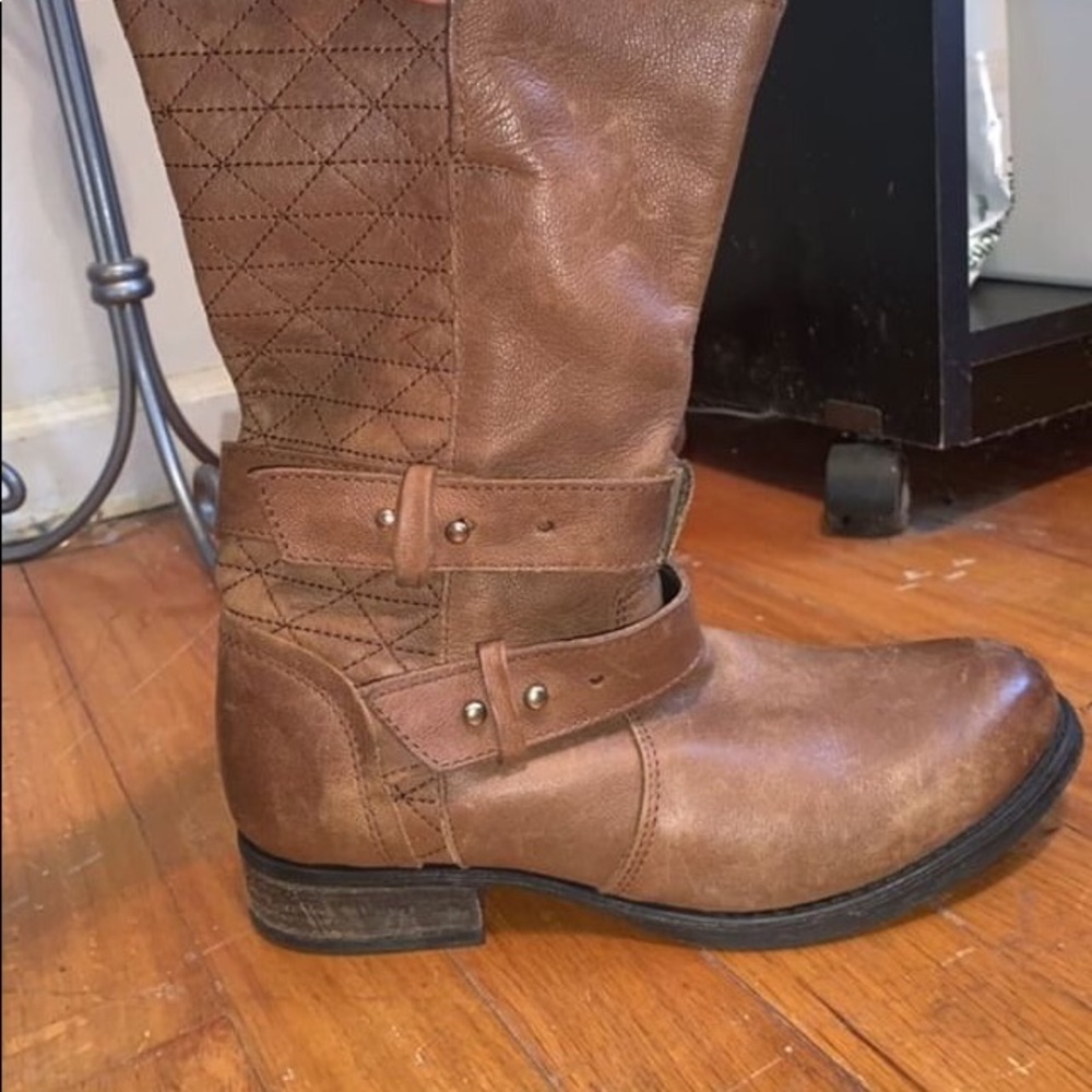 Brown mid high Steve Madden boots.